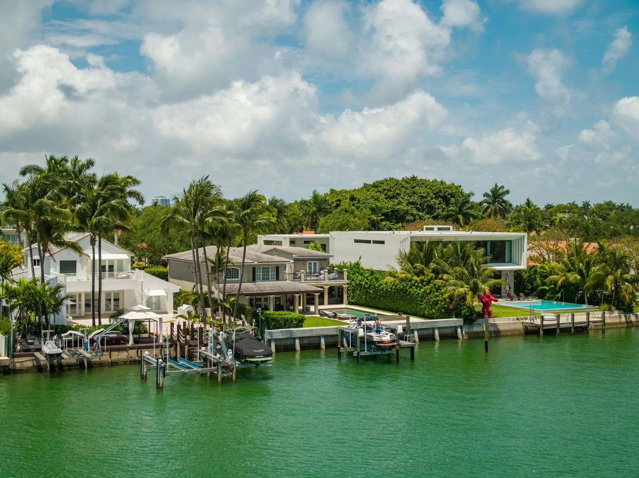 Waterfront estate in Miami Beach with pool, dock, and jet ski lifts