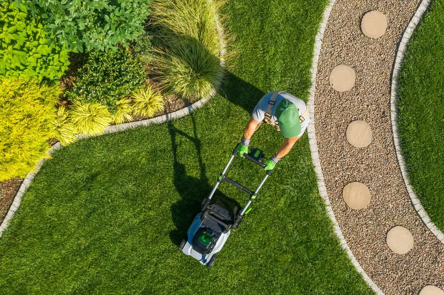 Technician mowing and maintaining an estate lawn