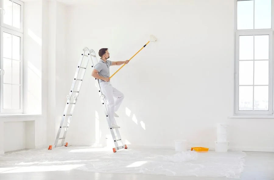 Technician painting an interior wall